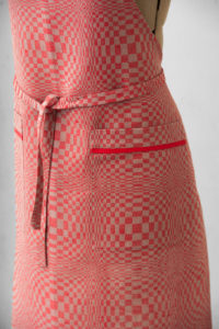 Red linen apron in checks pattern, with pockets. Manufacturer: AB “Siulas”