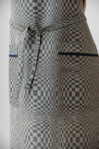 Blue - grey linen kitchen apron in checked pattern, with pockets. Manufacturer: AB “Siulas”, Lithuania